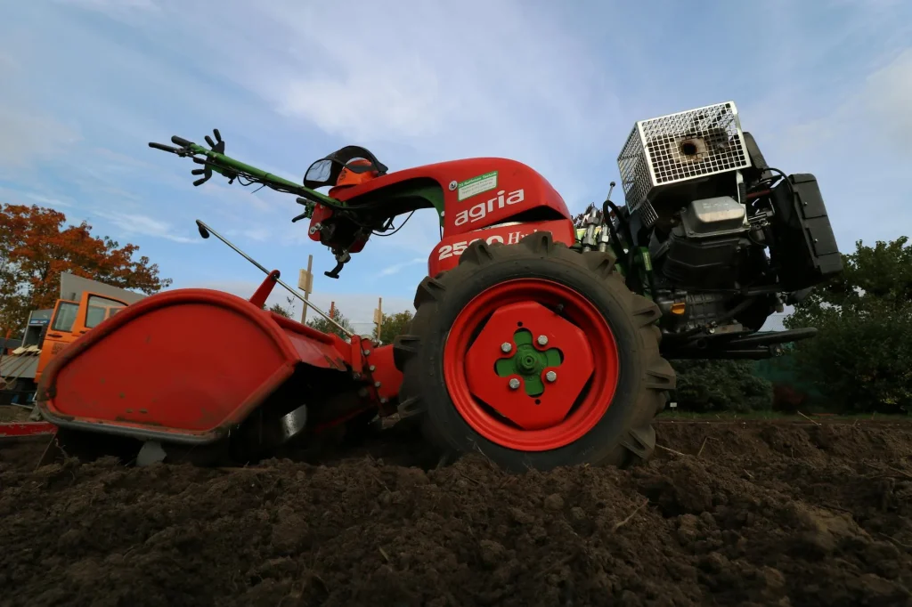 Garden tiller breaking up soil on an allotment plot