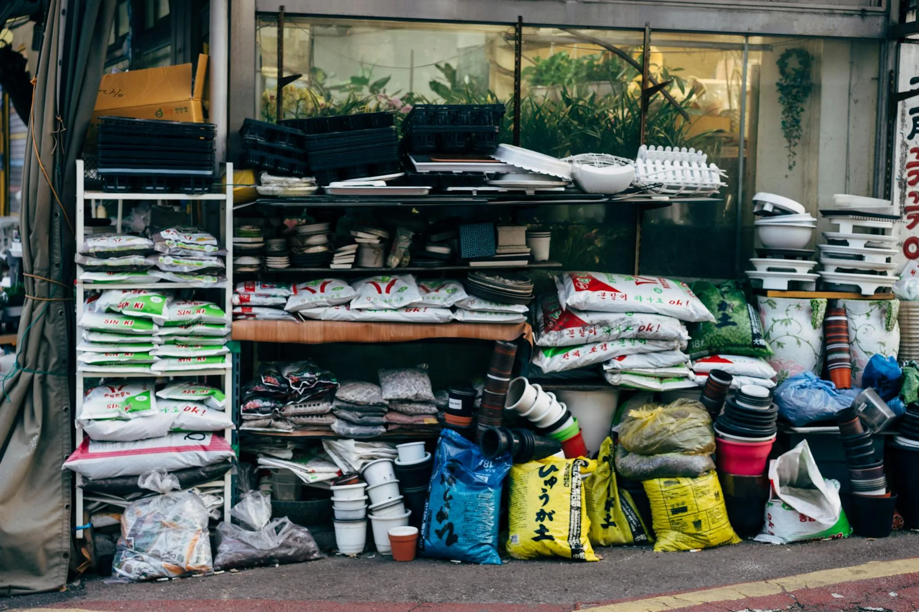 Bags of compost stacked at a garden centre