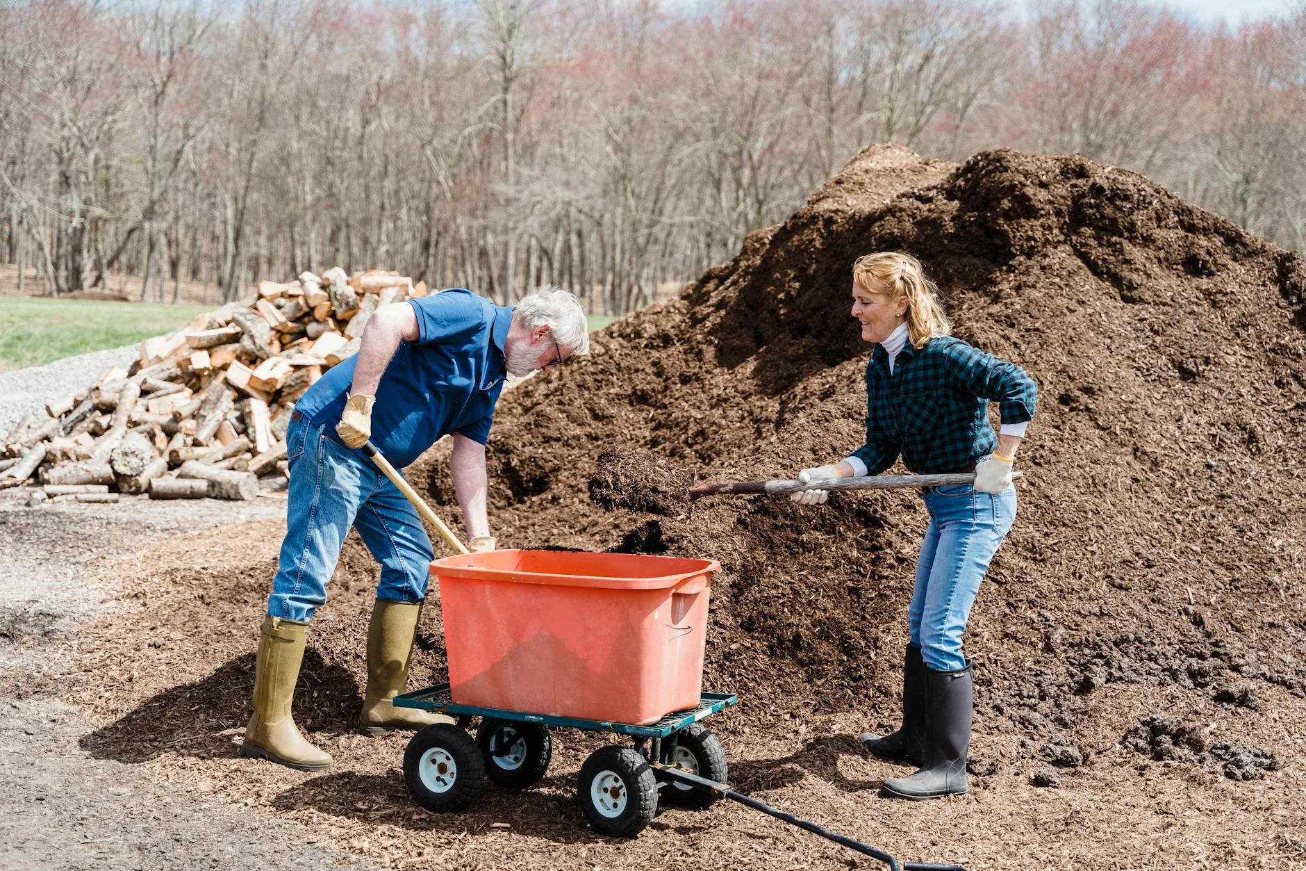 Rich compost being added to fill a raised garden bed
